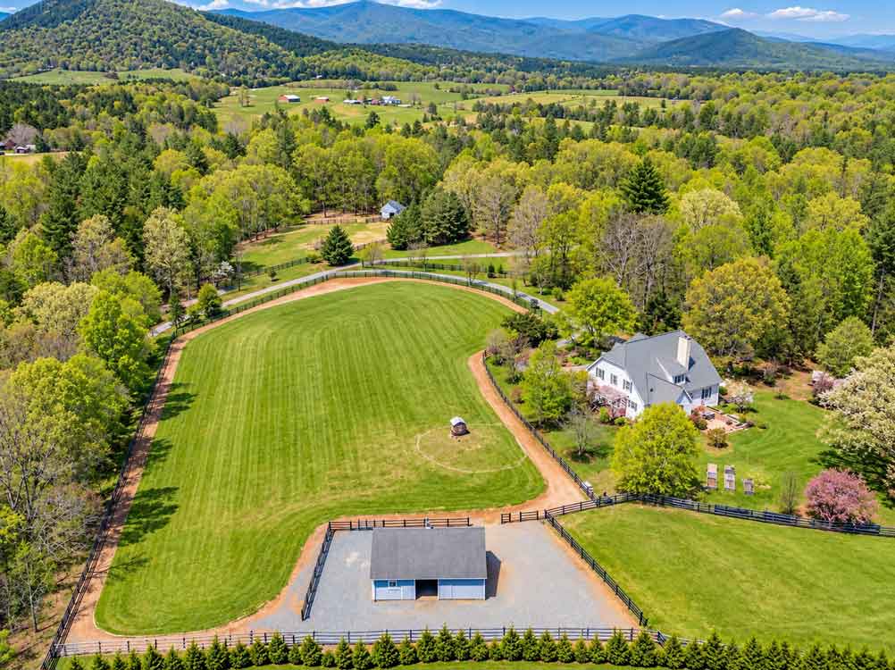 Earlysville, VA horse farm with fenced pastures, barn, country home, and Blue Ridge Mountain views